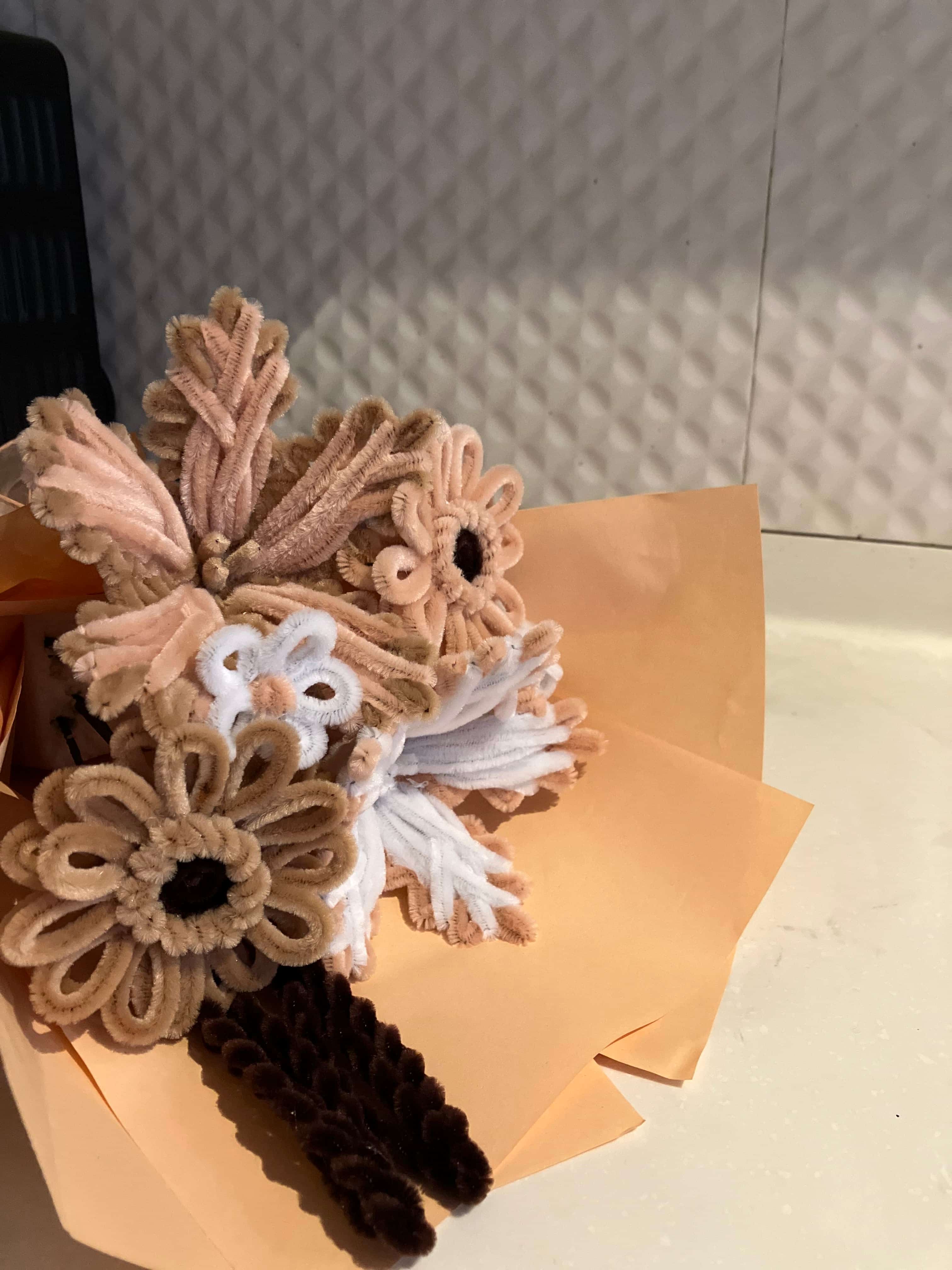Set of hair accessories including flowers and bands on a textured surface