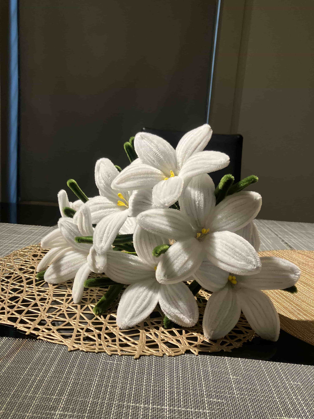 White flowers on a woven mat with a dark background