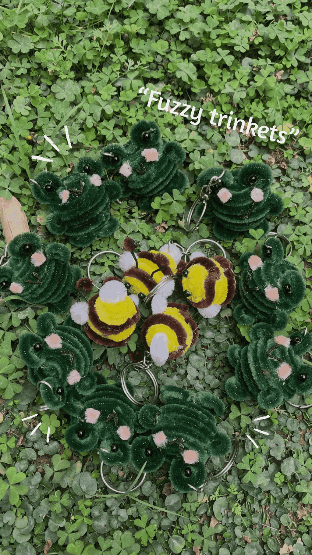 Fuzzy keychains shaped like bees and caterpillars on a green leafy background with 'Fuzzy trinkets' text.