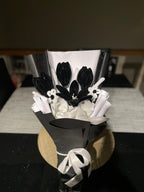 Black and white floral arrangement on a dark leather chair