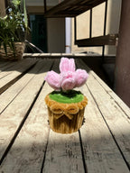 Cupcake with pink flower on a wooden surface
