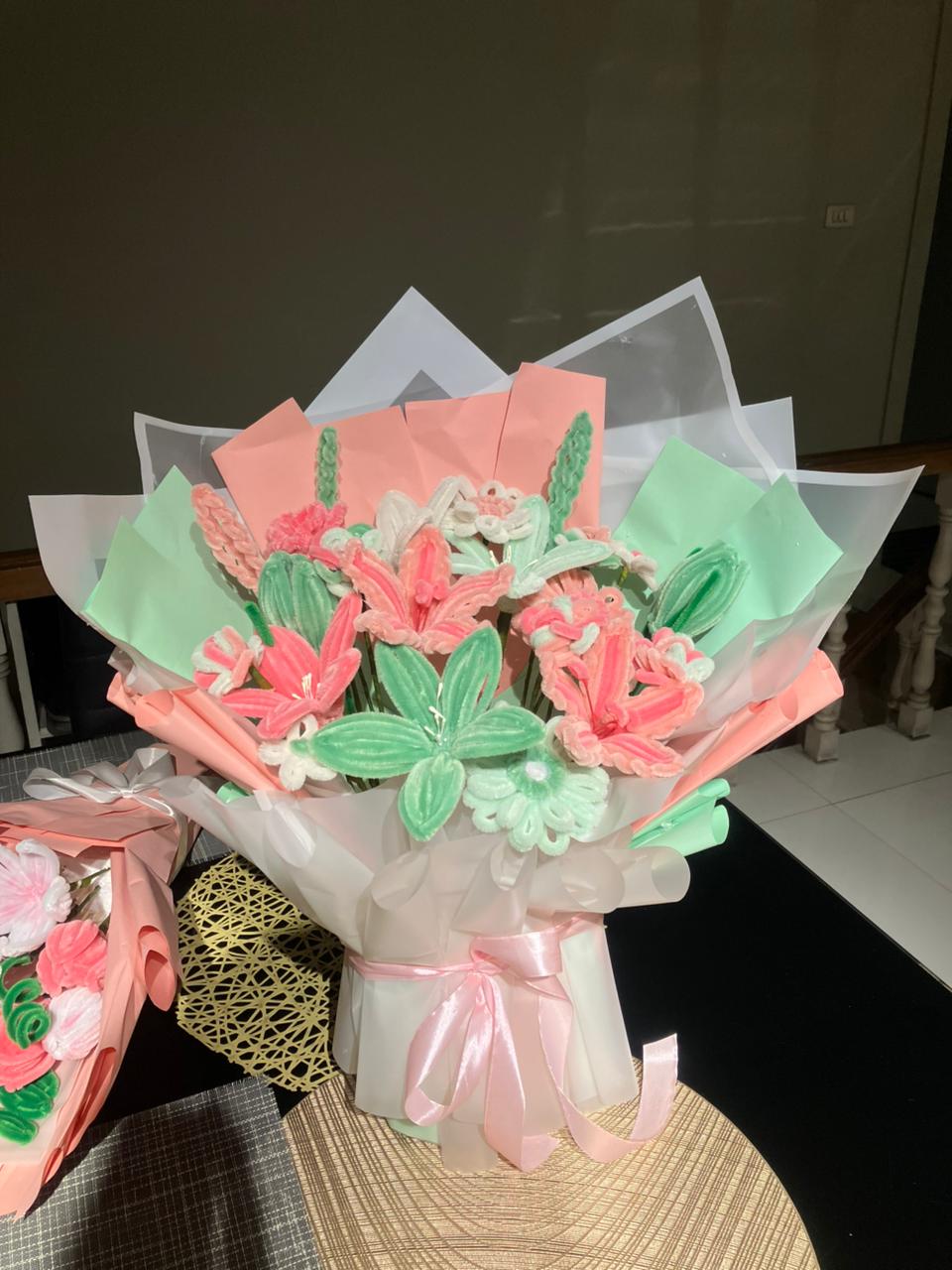Bouquet of cookies shaped like flowers and butterflies on a table.