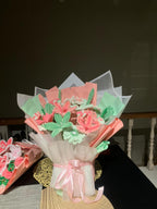 Bouquet of cookies shaped like flowers and leaves on a dark background