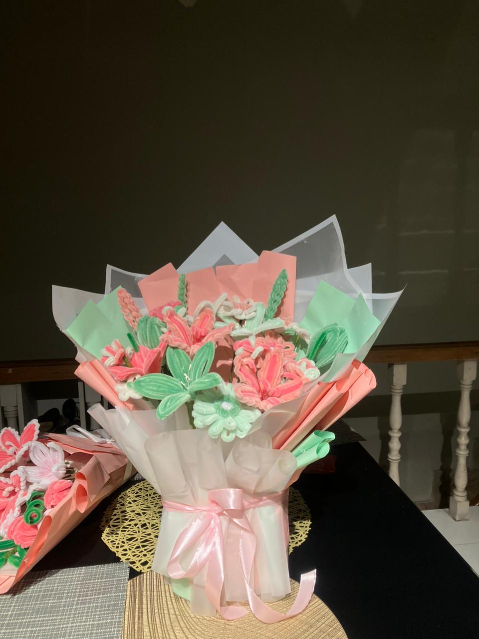 Bouquet of cookies shaped like flowers and leaves on a dark background
