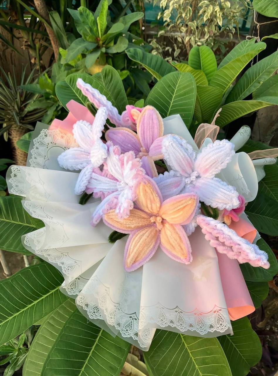 Decorative headpiece with pink and white flowers on a green leafy background