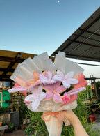 Bouquet of flowers held by a person with a blurred background